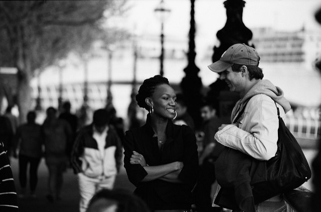  A couple, in a public place, enjoying conversation with each other.